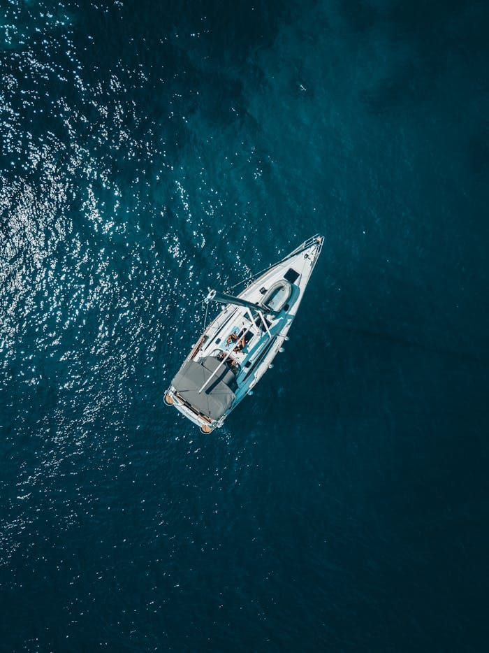 service-02 A stunning aerial shot of a sailboat cruising the deep blue waters of Croatia.